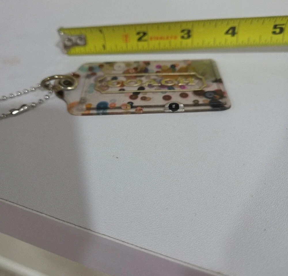 Coach Clear Confetti Acrylic Hang Tag  with Gold Logo